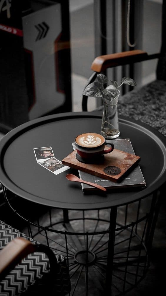 A latte on a moody cafe table at Cafe Tria